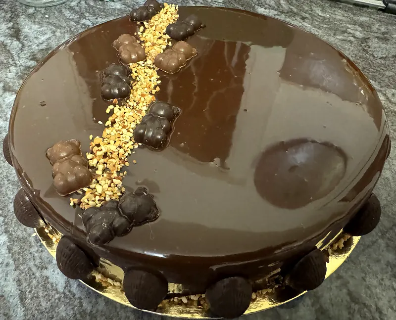 Entremets au glaçage chocolat miroir, oursons en chocolat et éclats de noisettes